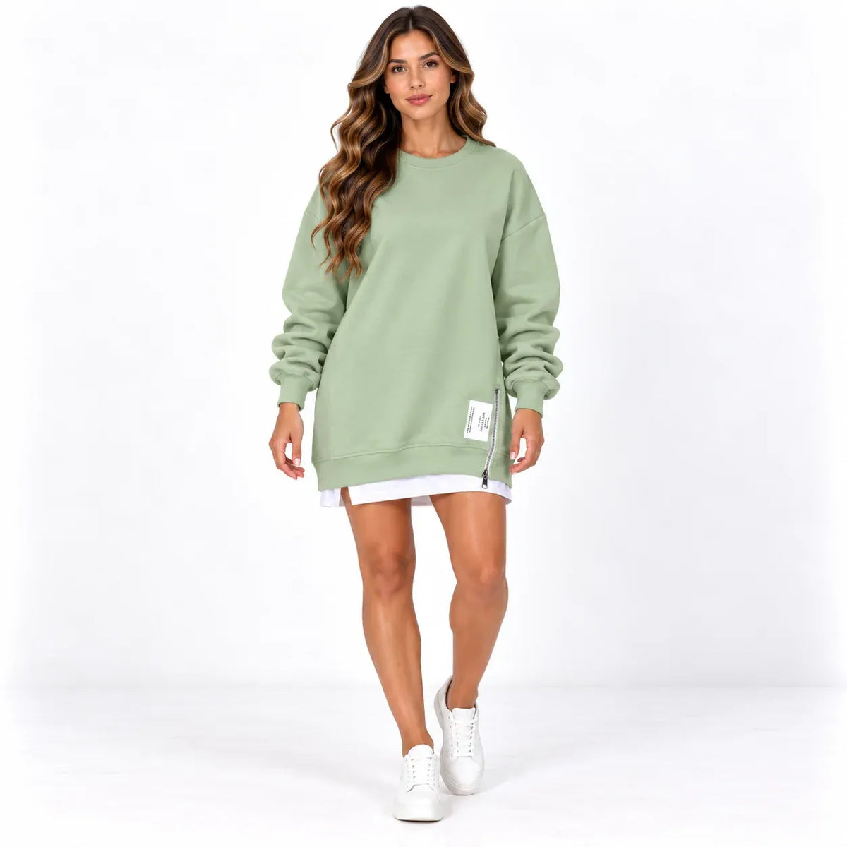 Sage green front: Model wearing a sage green sweater dress with a round neckline, cuffed sleeves, and side zipper detail.