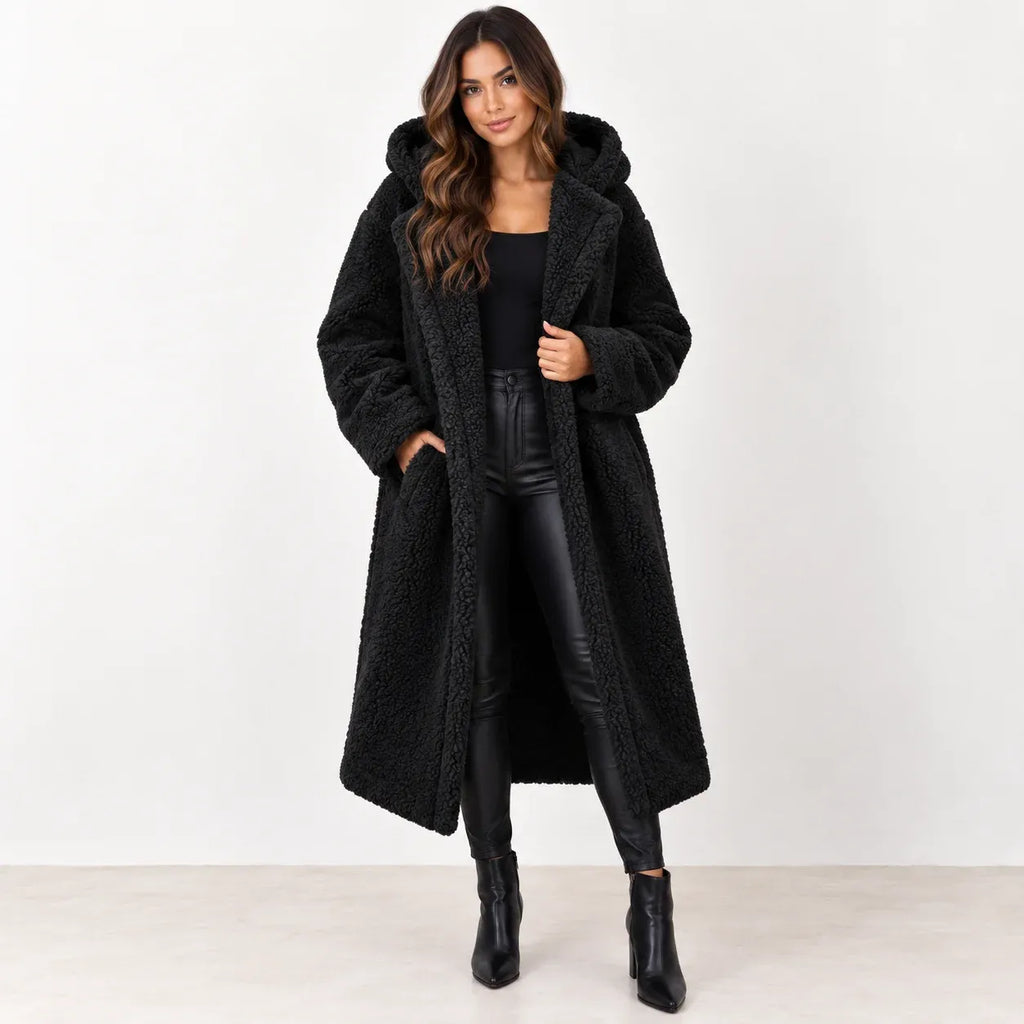 Black: Women's black longline teddy fleece coat with hood and wide lapels, shown from the front.