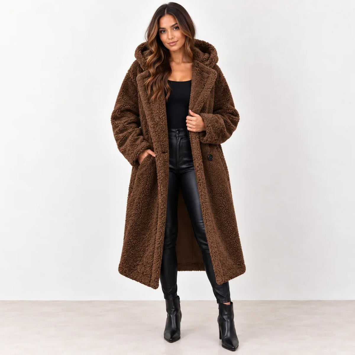 Brown: Women's brown hooded teddy fleece coat showing the long silhouette, front buttons, and hand pocket.