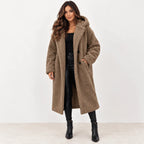 Camel: Women's camel longline teddy fleece coat with hood and dark buttons, styled with black pants and boots.
