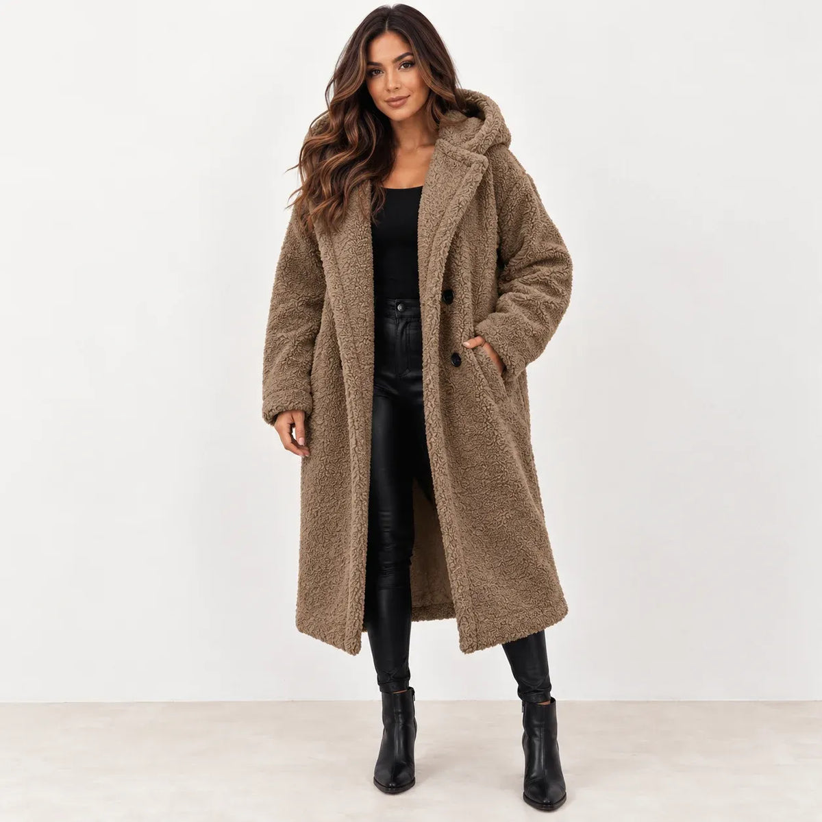 Camel: Women's camel longline teddy fleece coat with hood and dark buttons, styled with black pants and boots.