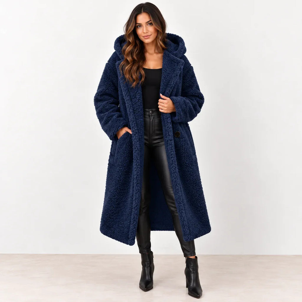 Dark blue: Women's dark blue hooded teddy fleece coat worn open over a black top and pants, front view.