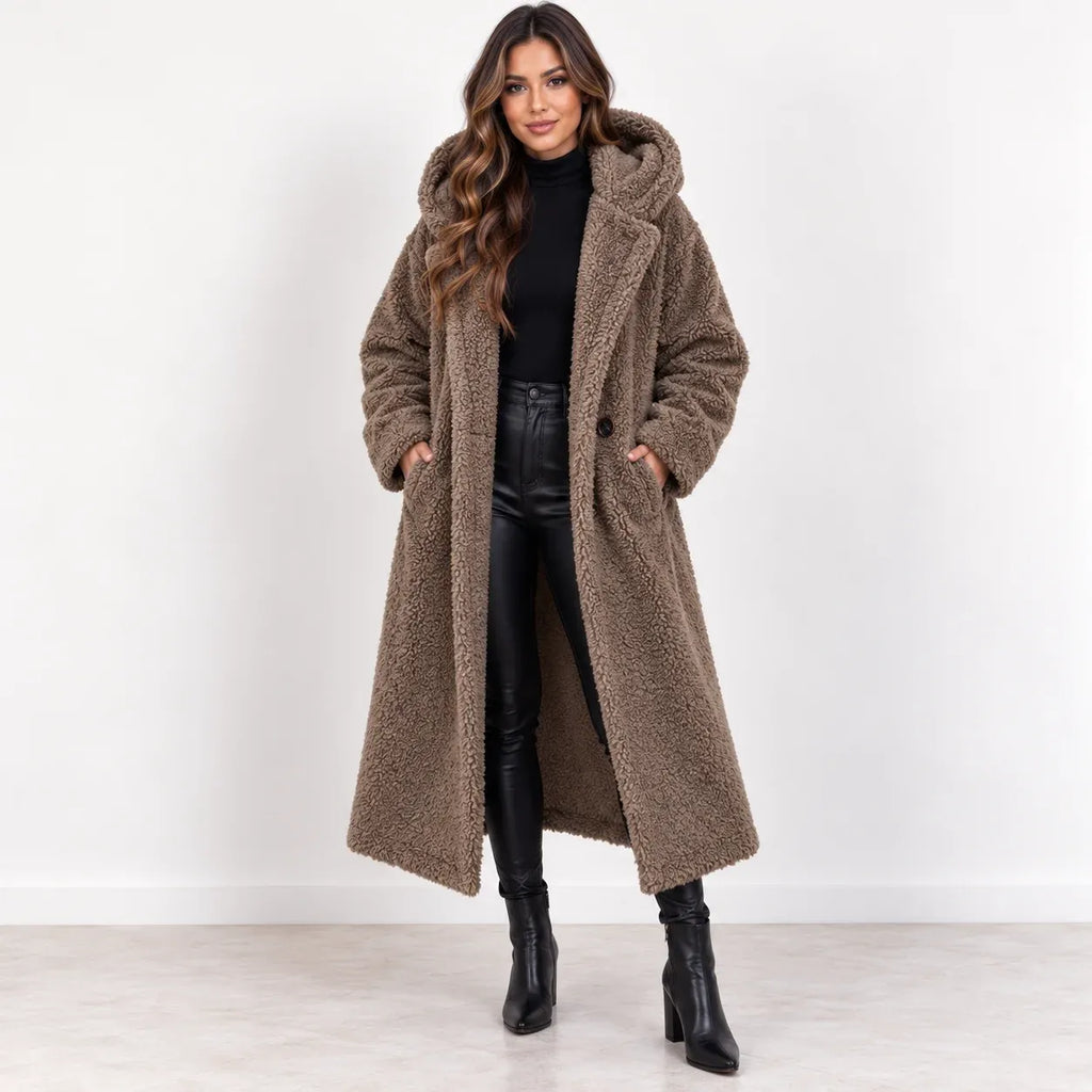 Khaki, front: Women's khaki longline teddy fleece coat with hood and front pockets, worn open over a black outfit.