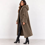 Khaki, side: Side view of women's khaki teddy fleece coat showing the hood, long sleeves, and below-knee hem.