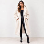 Off white: Women's off-white hooded teddy fleece coat with dark buttons, shown with both hands in the front pockets.