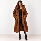 
Reddish brown: Women's reddish-brown longline teddy fleece coat worn open, showing the hood and front pockets.