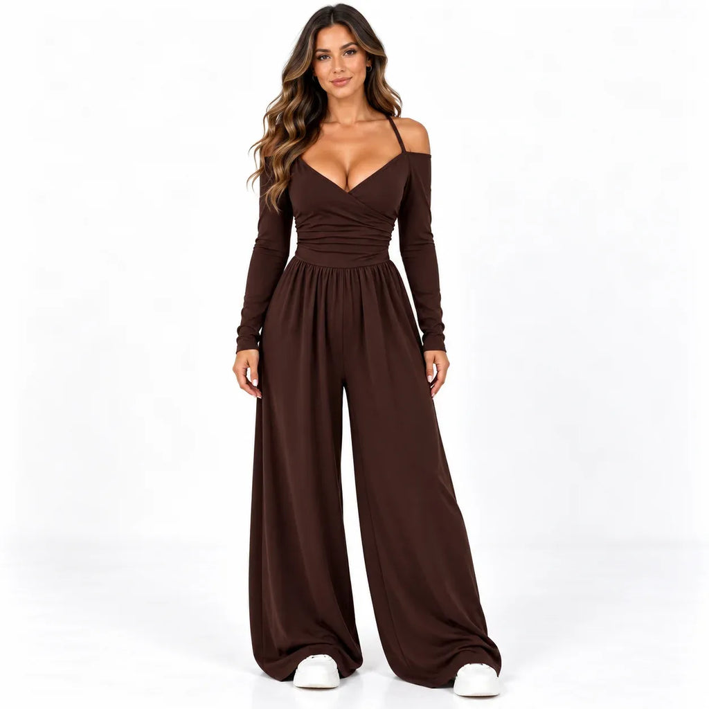 Brown front: Model wearing a brown off-shoulder wide-leg jumpsuit with a wrap-look neckline and gathered waist.