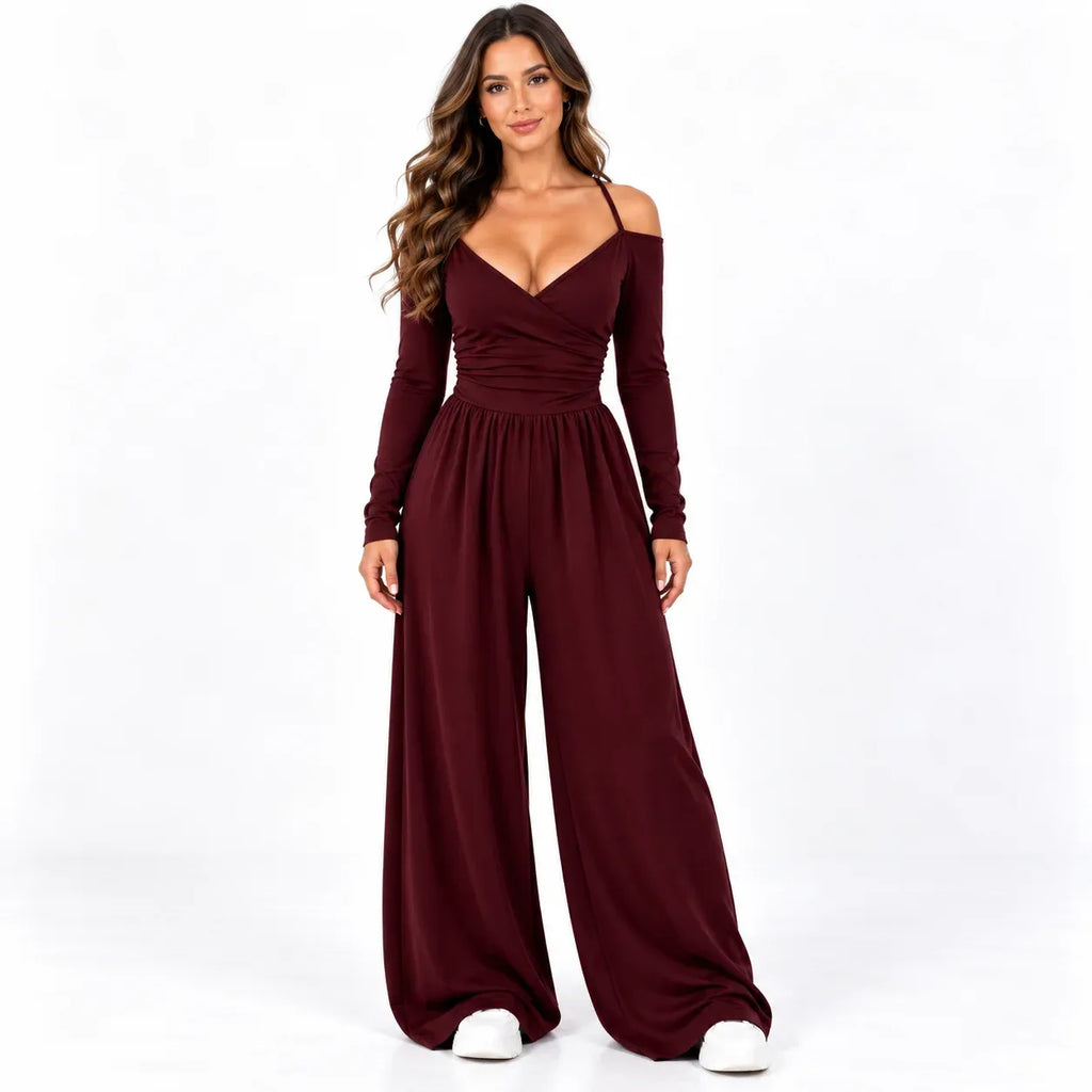 Burgundy front: Model wearing a burgundy off-shoulder wide-leg jumpsuit with long sleeves and a gathered bodice.