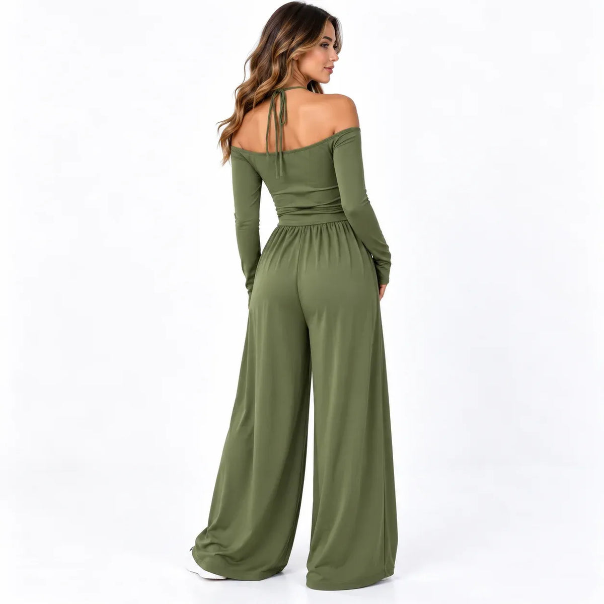 Olive green back: Back view of an olive green wide-leg jumpsuit showing an off-shoulder neckline and neck tie straps.