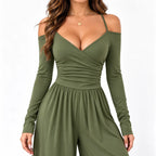 Olive green close-up: Close-up of an olive green jumpsuit showing slim straps, a wrap-look V-neckline, and gathered bodice detailing.