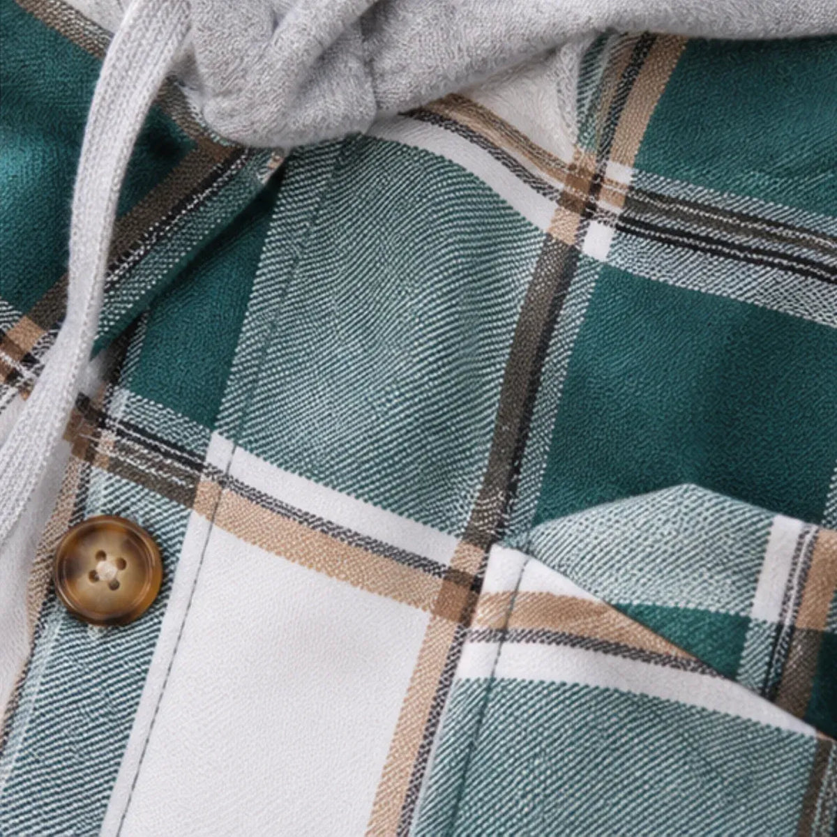 Close-up of a plaid hooded sweatshirt showing a green, white, and beige tartan pattern with a brown button and gray drawstring.