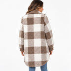A woman wearing a brown and off-white buffalo plaid sherpa fleece coat, shown from the back against a plain white background.