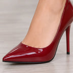 Close-up of women’s wine red pointed-toe stiletto high heels with glossy patent finish