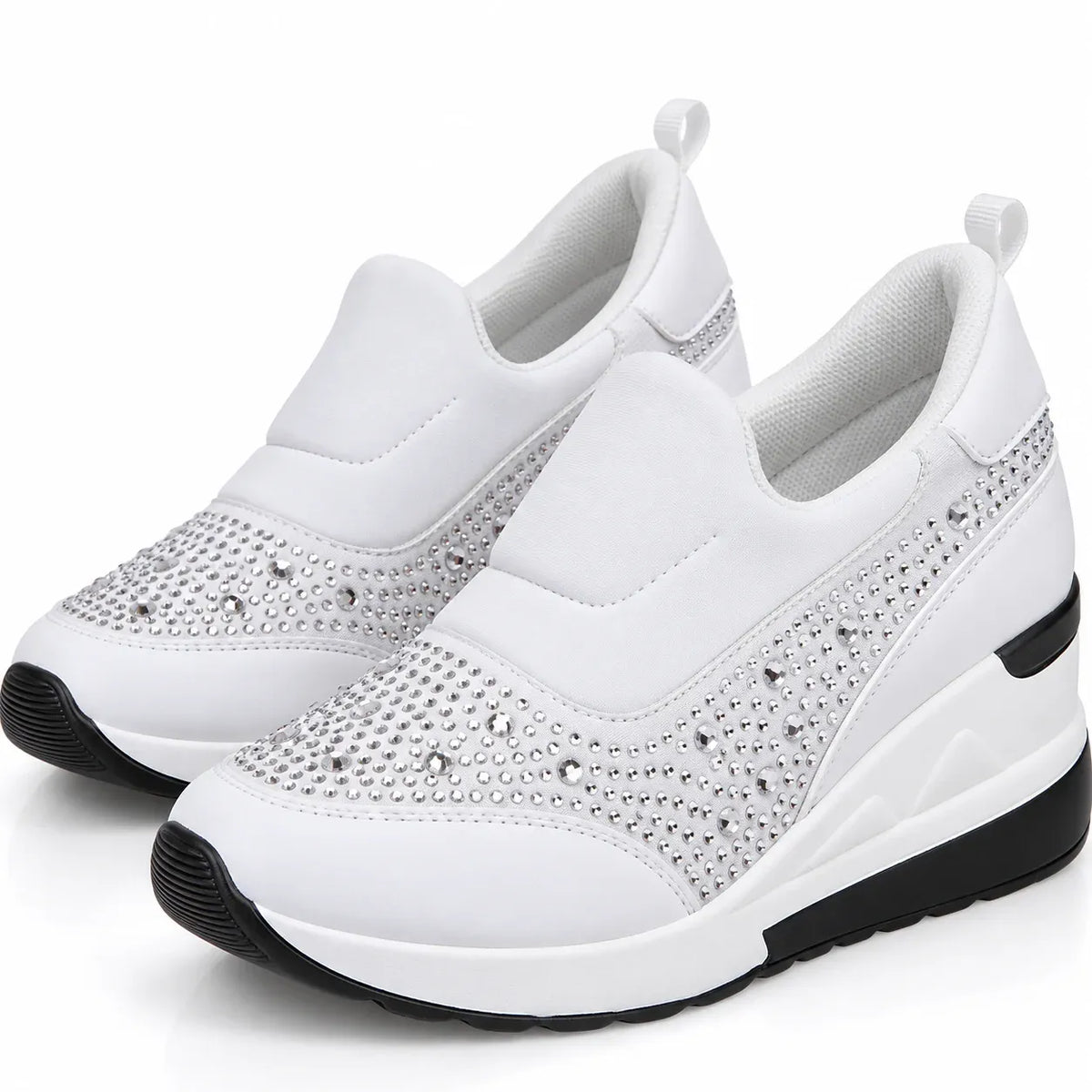 A pair of white slip-on wedge sneakers with silver rhinestone embellishments on the toe and side panels, featuring black outsole details, shown against a plain white background.