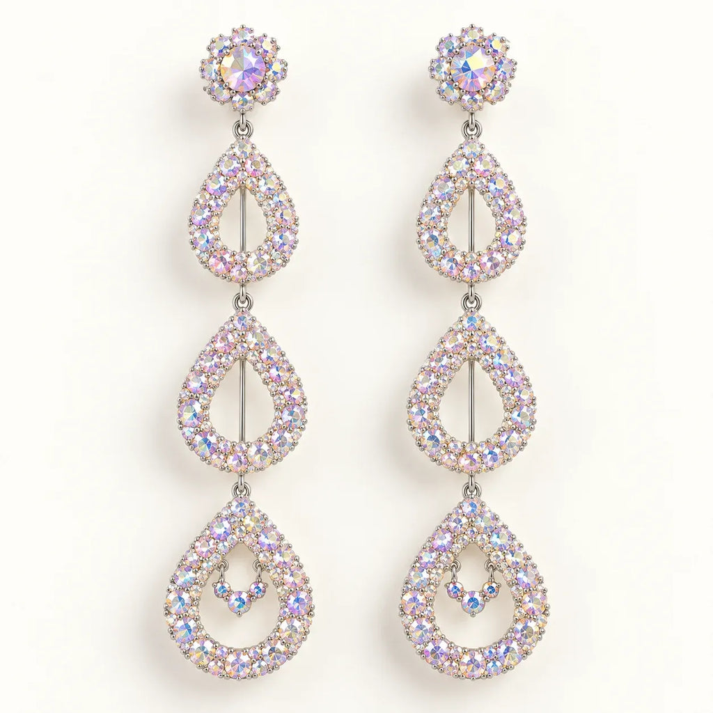 A pair of long drop earrings with a silver-tone metal setting and iridescent, rainbow-reflecting rhinestones, arranged vertically on a plain white background.