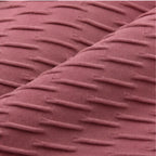 A close-up of a textured fabric with a dusty rose or mauve color and a raised horizontal stripe pattern.