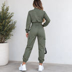 Back view of women’s olive green utility jogger two-piece set showing the cropped jacket, elastic waistband, cargo pockets, and black side strap detail.