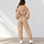 Back view of a beige fleece zip-up hoodie with black drawstrings, black zippers, and silver metal ring hardware.
