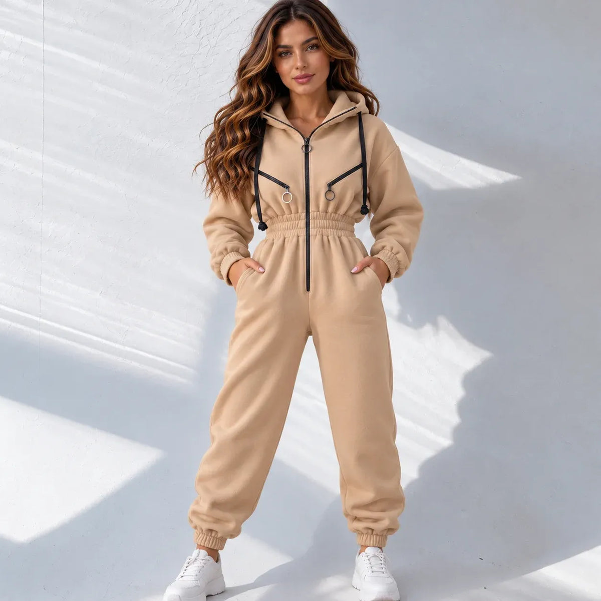 Front view of a beige fleece zip-up hoodie with black drawstrings, black zippers, and silver metal ring hardware.