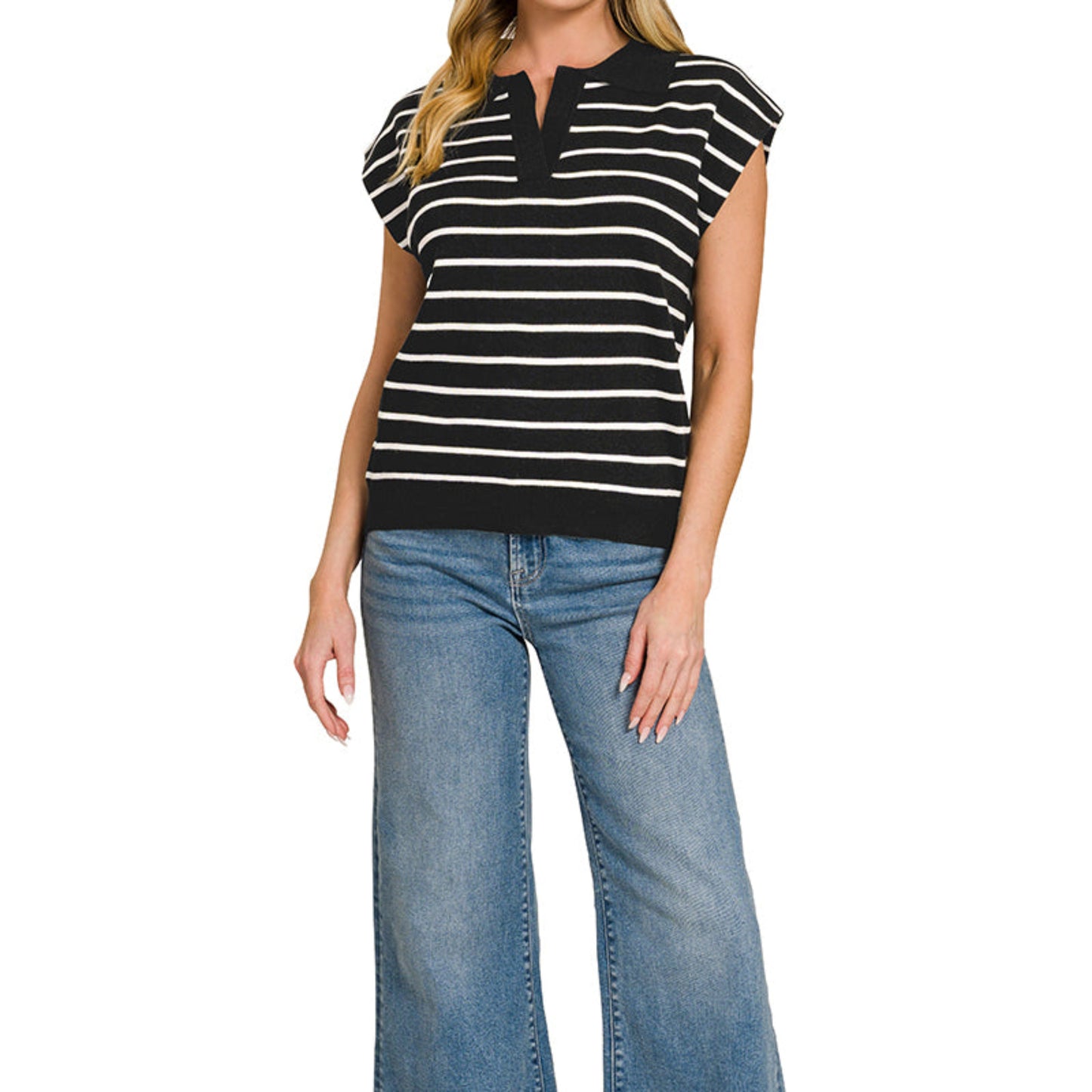 Woman wearing a black and white striped top and blue jeans on a white background