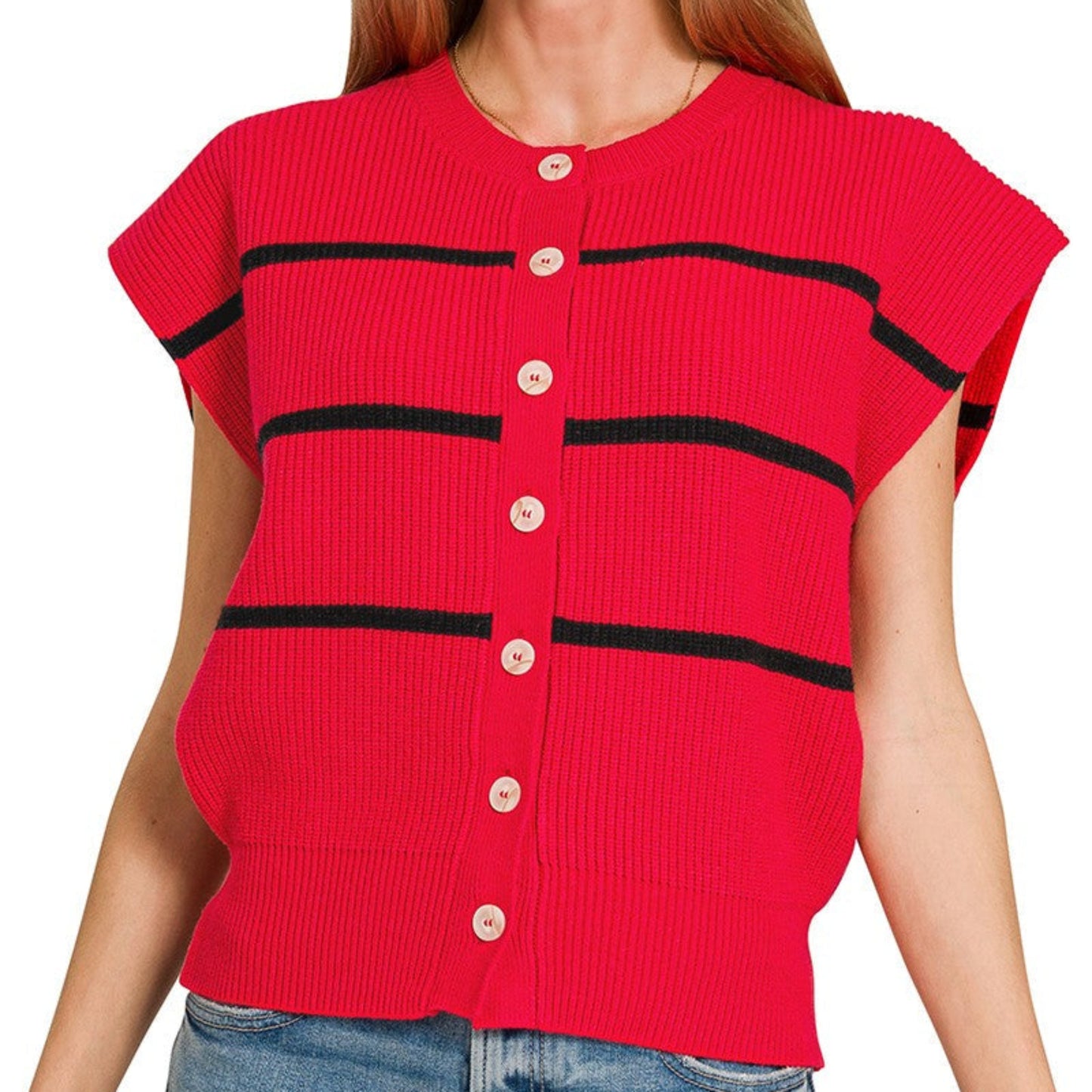 Woman wearing a red ribbed sweater with black stripes and buttons on a white background