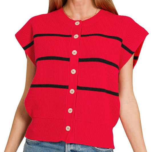Woman wearing a red ribbed sweater with black stripes and buttons on a white background