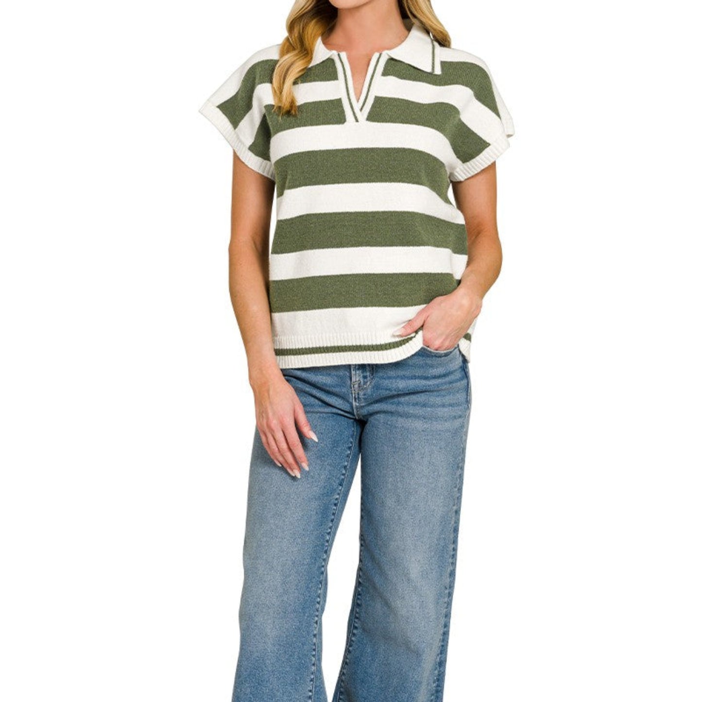Woman wearing a green and white striped shirt with blue jeans on a white background