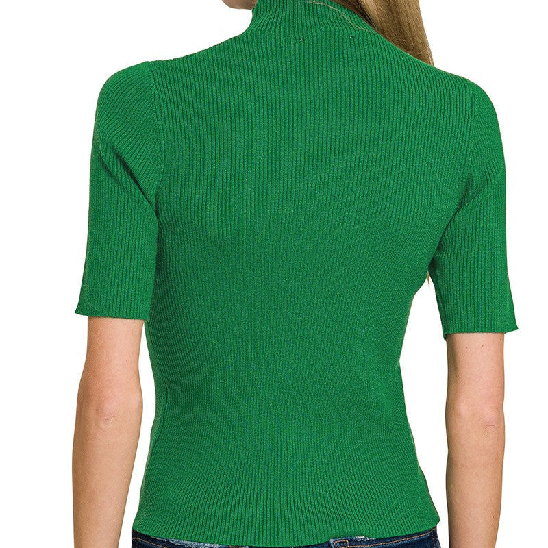 Green ribbed knit top worn by a person on a white background
