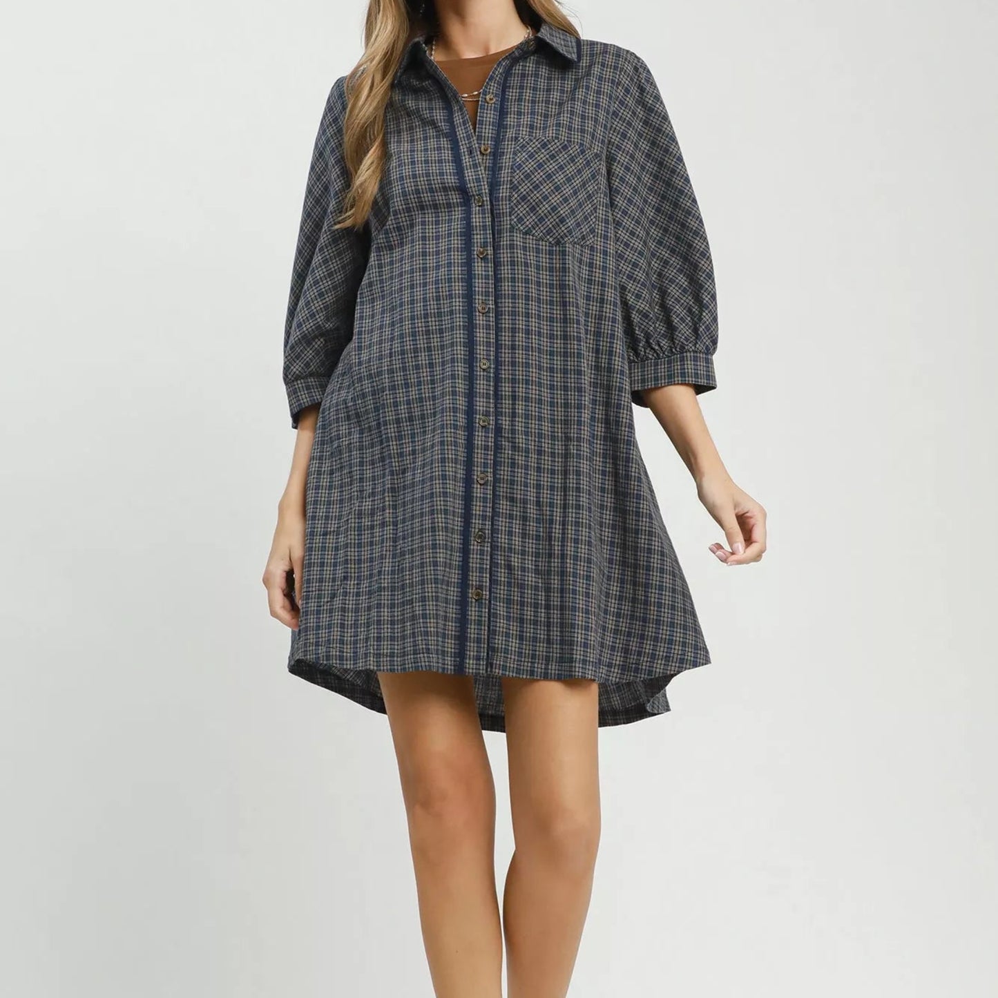 Model wearing a loose relaxed fit navy plaid Umgee shirt dress from Solazura Boutique