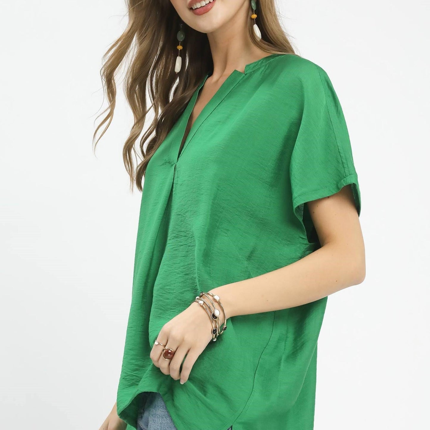 Lifestyle view of the Umgee flowy blouse paired with white denim for a fresh summer outfit.