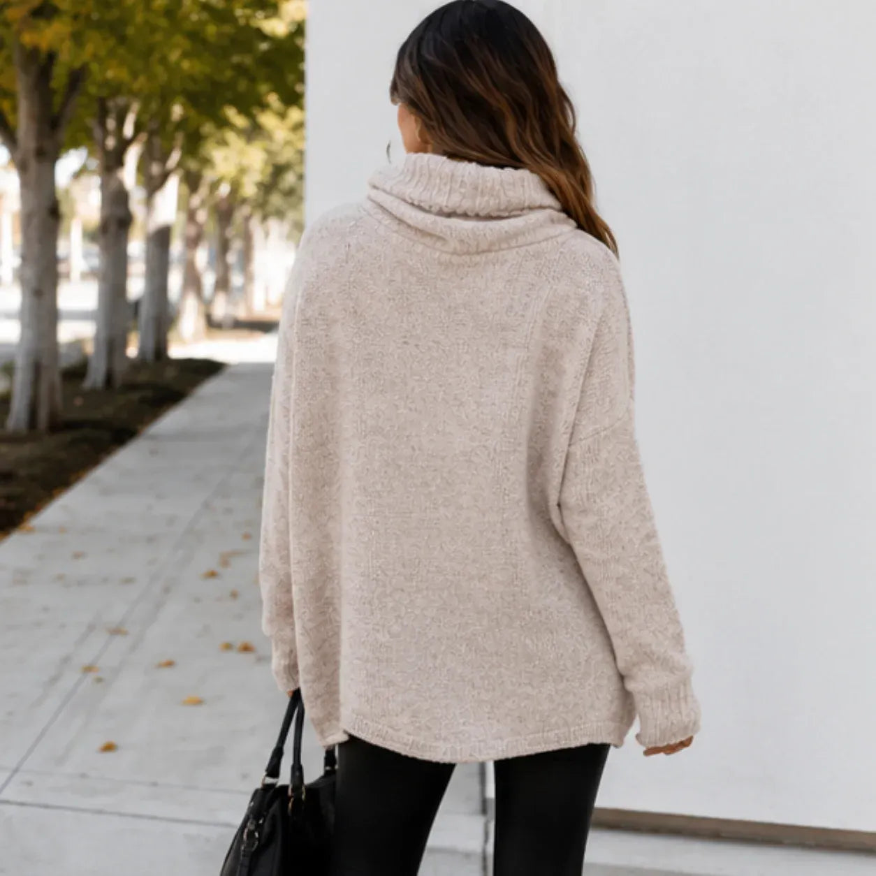 Back view of apricot oversized knit cowl neck pullover showing relaxed fit and cowl neckline