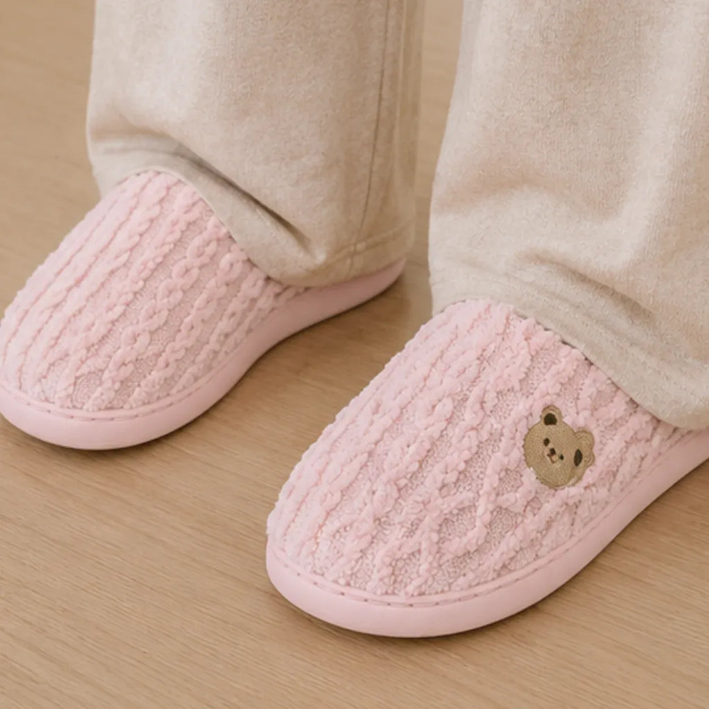 Women's Aspen Cozy Knit House Slippers in pink featuring a soft knit upper, embroidered bear detail, plush lining, and non-slip sole.