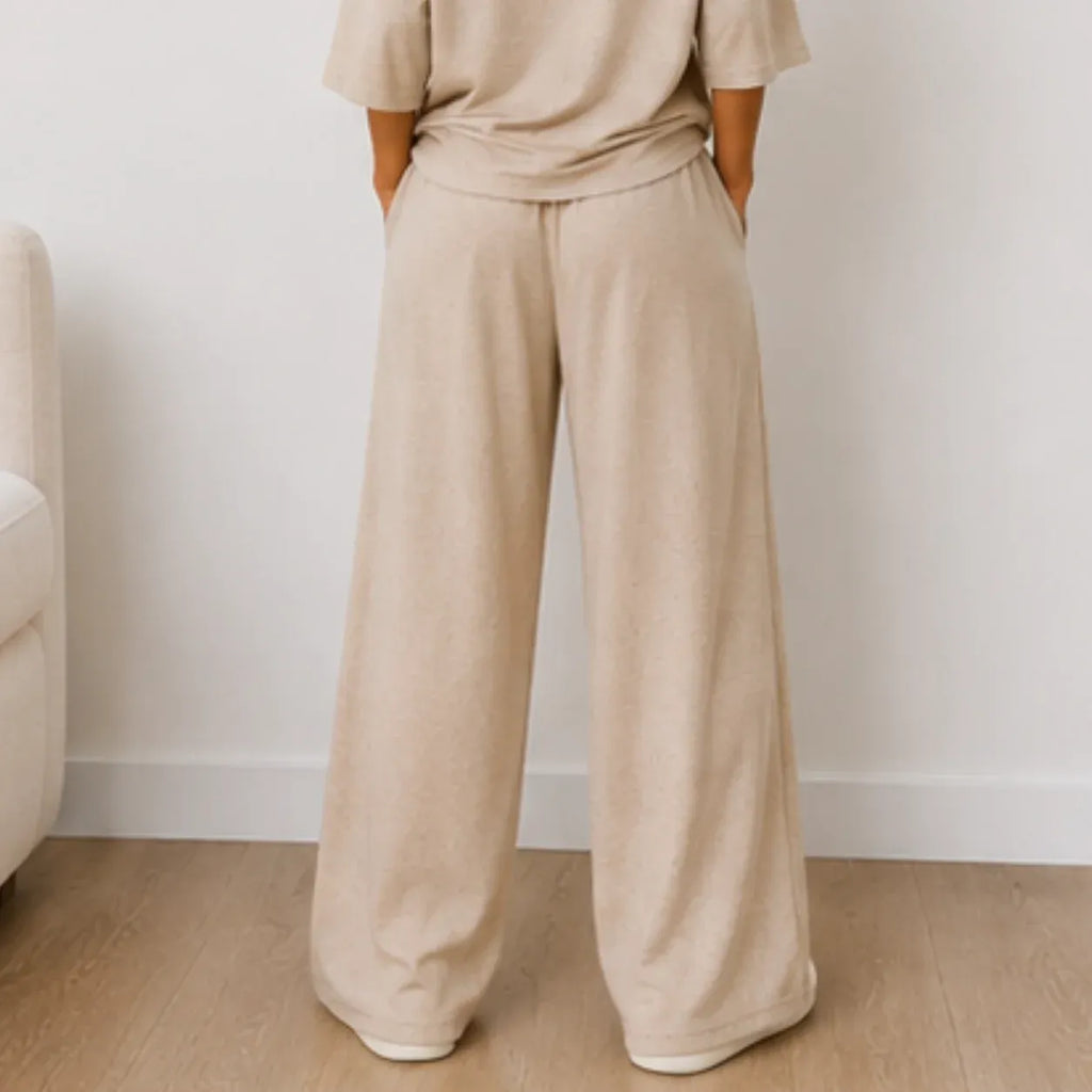 Back view of the women's Aspen Cozy Knit House Slippers in white showcasing the comfortable slip-on design and plush knit construction.