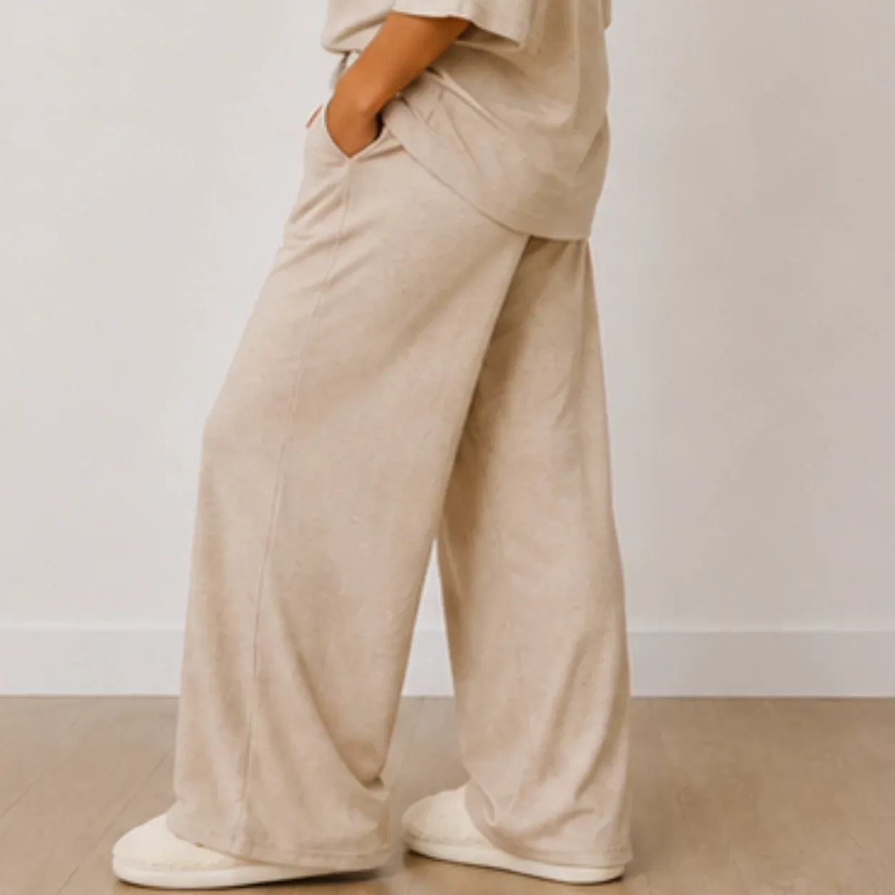 Side view of the women's Aspen Cozy Knit House Slippers in white with plush knit fabric, closed toe, and durable non-slip sole.