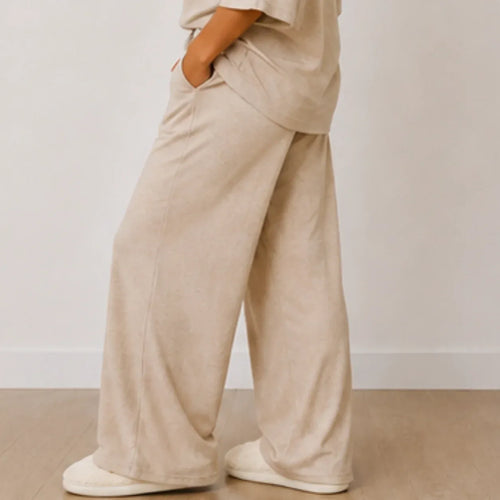 Side view of the women's Aspen Cozy Knit House Slippers in white with plush knit fabric, closed toe, and durable non-slip sole.
