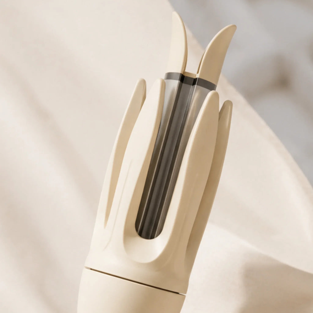 Close-up of the ceramic barrel on an ivory automatic rotating curling iron.