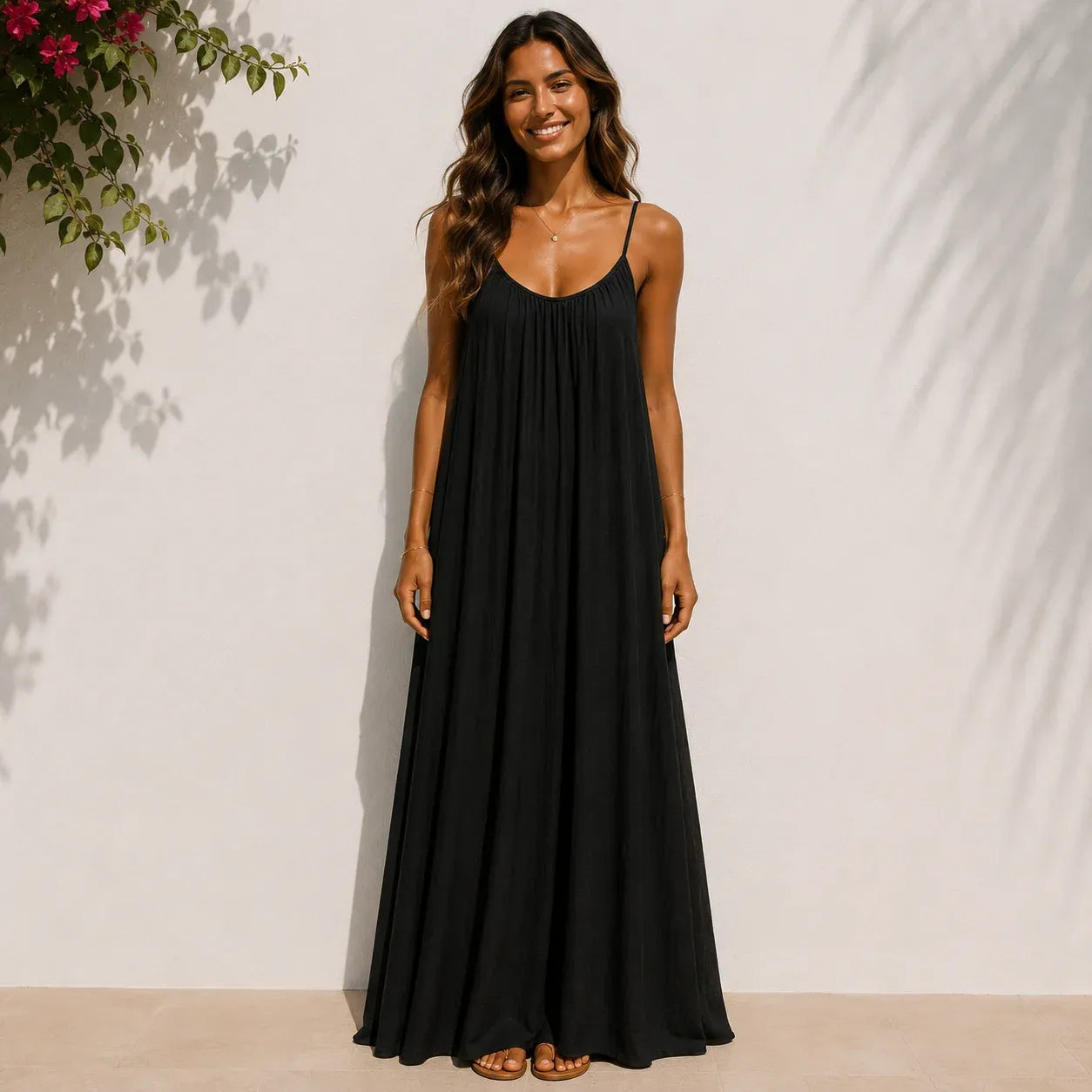Women's black backless cami maxi dress with a relaxed flowy fit.