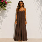 Women's brown backless cami maxi dress with a sleeveless flowy design.