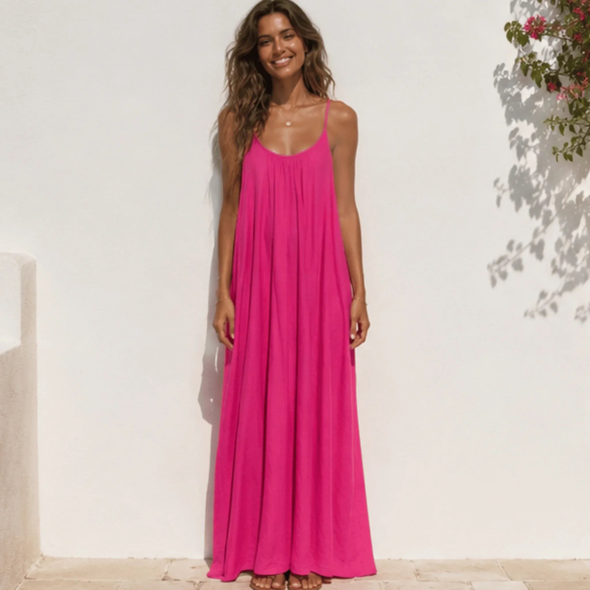 Front view of a women's hot pink backless cami maxi dress with a relaxed flowy silhouette.