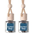 Two small clear glass reed diffusers with beige wooden tops and hanging cords, each labeled Barber Shop, on a white background.