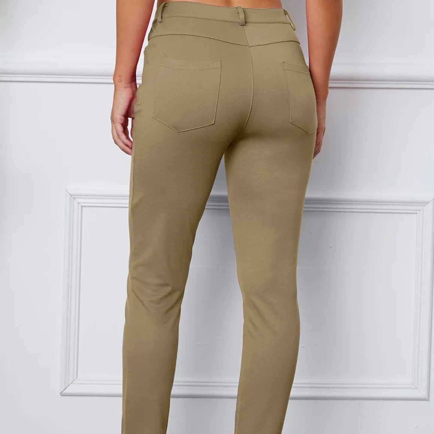 Khaki pants worn by a person on a white background
