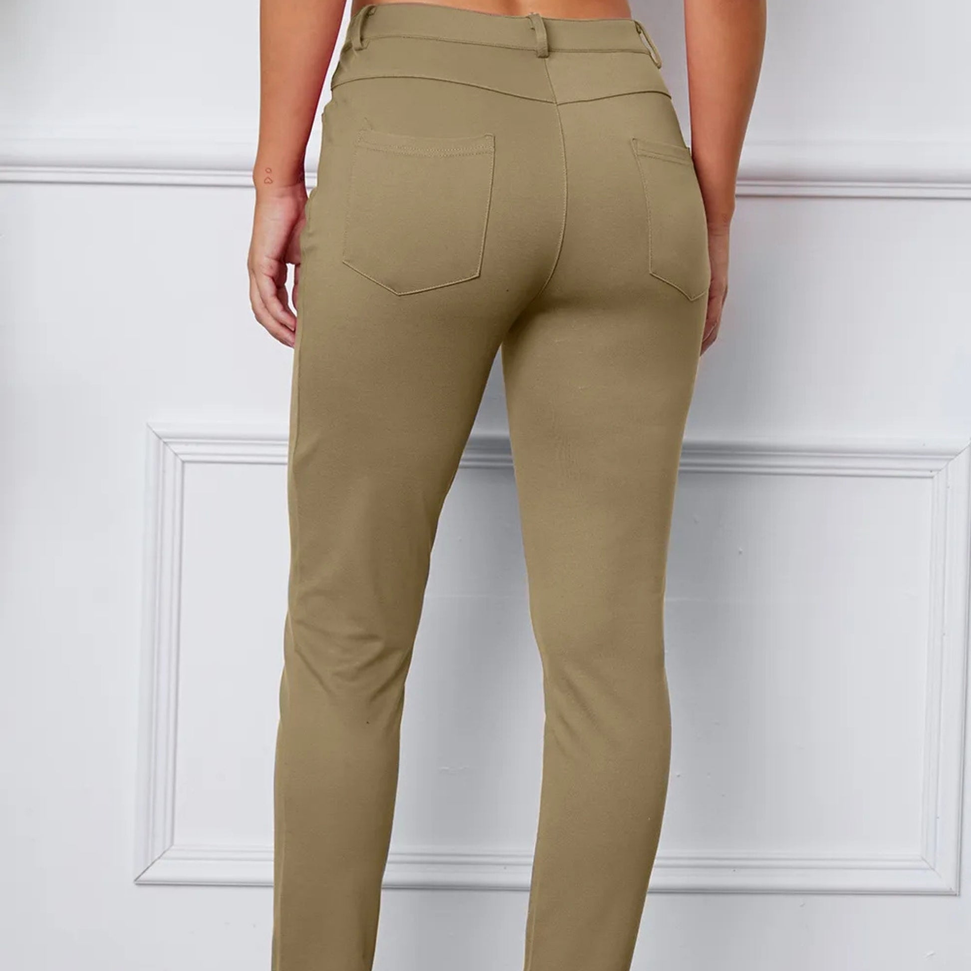 Khaki pants worn by a person on a white background