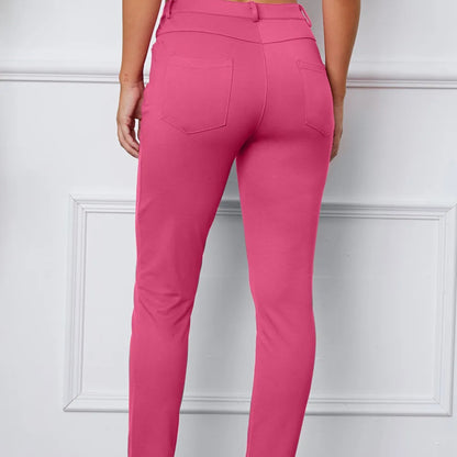 Pink pants worn by a person on a white background