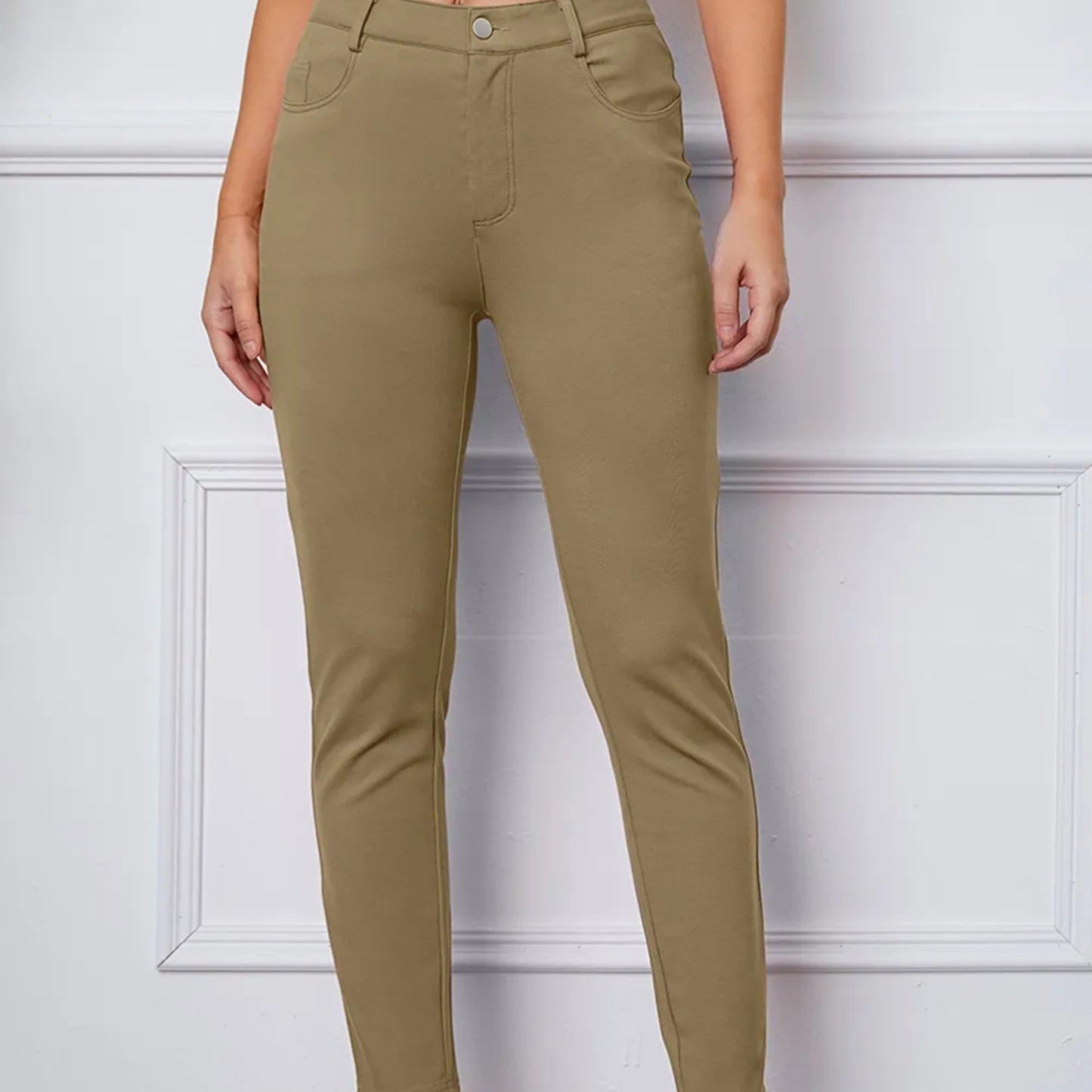 Khaki pants worn by a person against a white background
