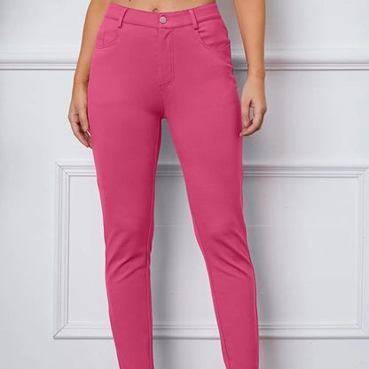 Pink pants worn by a person against a white wall