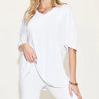 Women's white oversized lounge set with a relaxed V-neck short sleeve top and matching biker shorts.