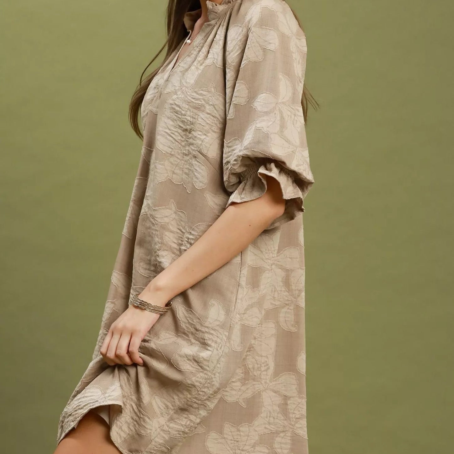 Close up shot of the intricate woven floral jacquard pattern fabric on a taupe Umgee dress from Solazura Boutique