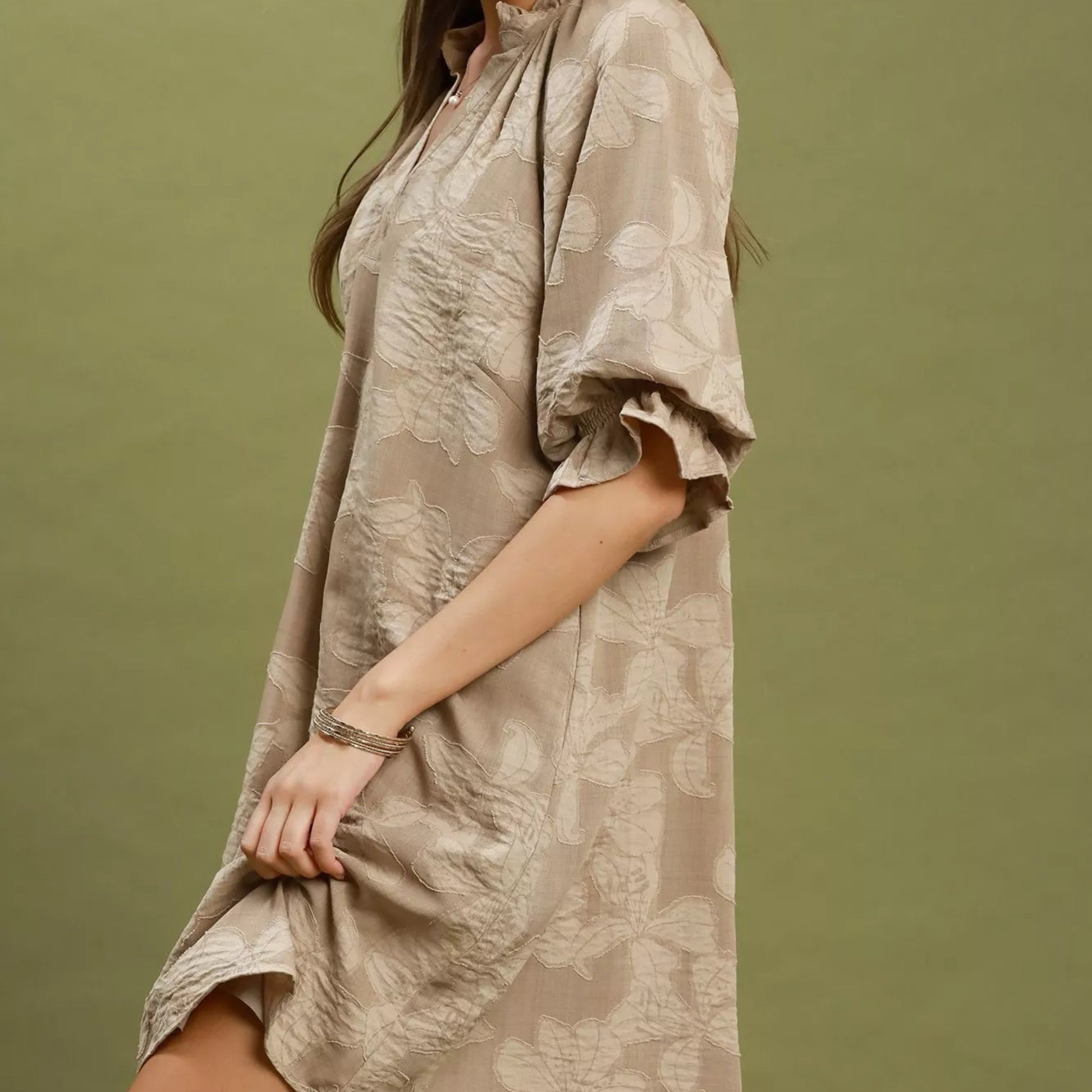 Close up shot of the intricate woven floral jacquard pattern fabric on a taupe Umgee dress from Solazura Boutique