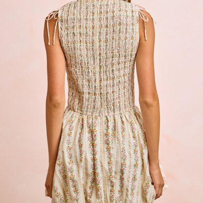 Floral dress worn by a person on a pink background