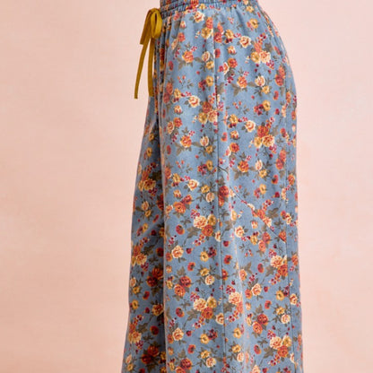 Floral-patterned skirt with a yellow ribbon on a pink background